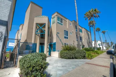 a building with palm trees in front of it at 901 S Pacific in Oceanside