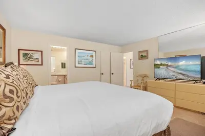 a bedroom with a white bed and a flat screen tv at Ocean Infinity - DMBC727B in Solana Beach