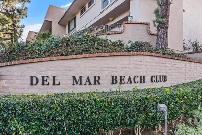 a sign for del mar mar beach club in front of a building at Ocean Infinity - DMBC727B in Solana Beach