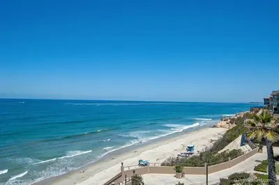 a view of a beach with palm trees and the ocean at Ocean Infinity - DMBC727B in Solana Beach