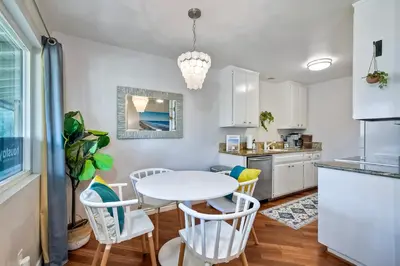 a kitchen and dining room with a white table and chairs at 3080 Lincoln - Unit 12 in Carlsbad
