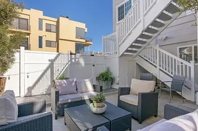 a patio with chairs and a table and stairs at 3690 Carlsbad Boulevard - Unit D in Carlsbad