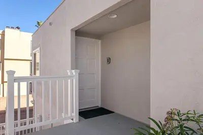 a stairway with a white door in a house at 3690 Carlsbad Boulevard - Unit D in Carlsbad