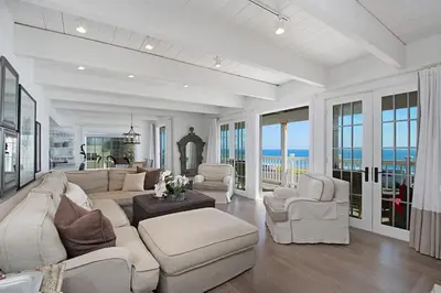 a living room with white furniture and a view of the ocean at 3690 Carlsbad Boulevard - Unit B in Carlsbad