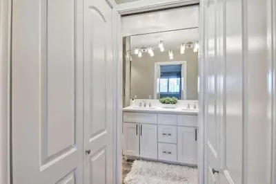 a white bathroom with a sink and a mirror at 1445 S Pacific Street Unit E in Oceanside