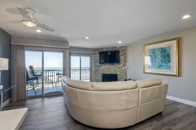 a living room with a large couch and a fireplace at 1445 S Pacific Street Unit E in Oceanside