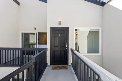 a hallway with a black door in a house at 1317 S Pacific - Entire Home in Oceanside