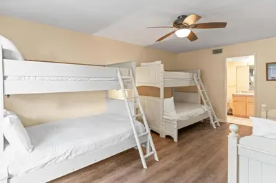 a bedroom with two bunk beds and a ceiling fan at 1317 S Pacific - Unit C in Oceanside