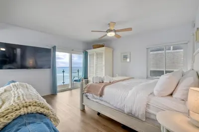 a bedroom with a bed and a ceiling fan at 1409 S Pacific Street 5BR in Oceanside