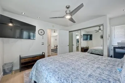 a bedroom with a bed and a clock on the wall at 1128 Tait Street Unit D in Oceanside