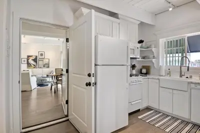 a kitchen with white cabinets and a white refrigerator at 3690 Carlsbad Boulevard - Entire Home in Carlsbad