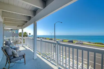a balcony with a chair and a view of the ocean at 3690 Carlsbad Boulevard - Entire Home in Carlsbad