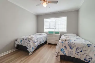 a bedroom with two beds and a window at Steps to ocean & bay large patio 4 parking spots in San Diego