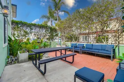 a patio with a picnic table and blue benches at Steps to ocean & bay large patio 4 parking spots in San Diego