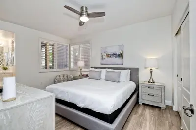 a white bedroom with a bed and a ceiling fan at 4025 Canario Street in Carlsbad