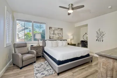 a bedroom with a bed and a chair at 4025 Canario Street in Carlsbad