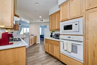 a kitchen with white appliances and wooden cabinets at 4025 Canario Street in Carlsbad
