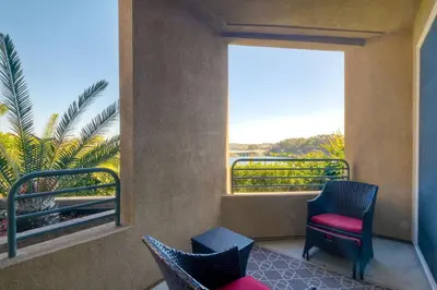 a balcony with two chairs and a window at 4025 Canario Street in Carlsbad