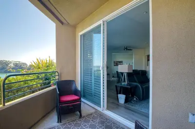 a balcony with a chair and a living room at 4025 Canario Street in Carlsbad