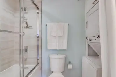 a bathroom with a shower and a toilet and towels at Oceanview Suite Hilltop in San Diego