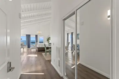 a hallway with a glass door leading to a living room at 1317 S Pacific Unit B in Oceanside