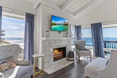 a living room with a fireplace and a tv at 1317 S Pacific Unit B in Oceanside