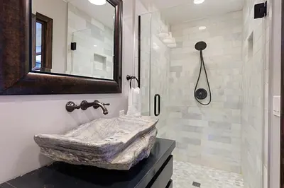 a bathroom with a stone sink and a shower at 5194 Carlsbad - Entire Home in Carlsbad