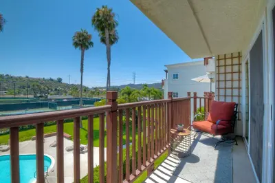 a balcony with a chair and a swimming pool at 2003 Costa Del Mar Road - Unit 678 in Carlsbad