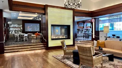 a living room with a couch and a dining room at 2003 Costa Del Mar Road - Unit 678 in Carlsbad