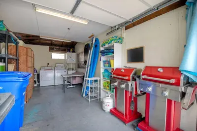a garage with a room with a surfboard on the wall at 165 n 167 Tamarack in Carlsbad