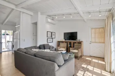 a living room with a couch and a tv at 180 n 190 Walnut Entire Home in Carlsbad