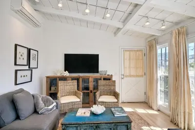 a living room with a couch and a tv at 180 n 190 Walnut Entire Home in Carlsbad