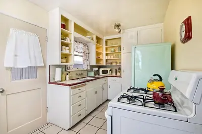 a kitchen with a stove with a tea kettle on it at 167 Tamarack in Carlsbad