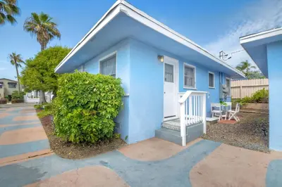 a blue house with a white door at 165 Tamarack in Carlsbad