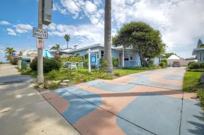 a house with a street sign on the sidewalk at 165 Tamarack in Carlsbad