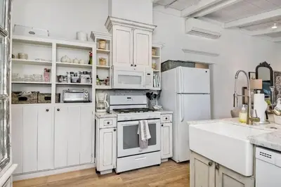 a kitchen with white appliances and white cabinets at 190 Walnut in Carlsbad