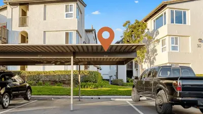 a truck parked in a parking lot in front of a building at Walk to Beach Pool Hot Tub Private Patio Parking Seabreeze Retreat in Dana Point
