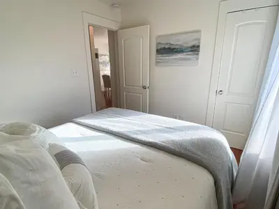 a white bedroom with a bed in a room at Hideaway in the heart of San Diego in San Diego