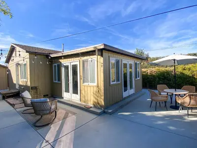 a tiny house with chairs and a table and an umbrella at Hideaway in the heart of San Diego in San Diego