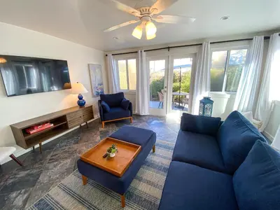 a living room with a blue couch and a tv at Hideaway in the heart of San Diego in San Diego