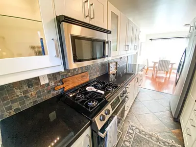 a kitchen with a stove and a microwave at Hideaway in the heart of San Diego in San Diego