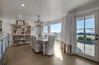 a dining room with a table and chairs and a window at 3636 Carlsbad Blvd - Entire Home in Carlsbad