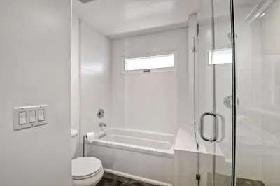 a bathroom with a tub and a toilet and a shower at 3636 Carlsbad Blvd - Entire Home in Carlsbad
