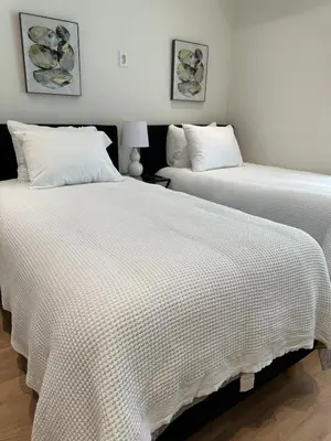 two beds sitting next to each other in a bedroom at Irvine Gem Luxury condo 31 days min near Irvine Business & UCI Hospital in Irvine