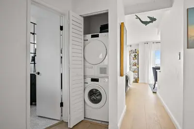 a white laundry room with a washer and dryer at Majestic Mermaid Retreat in San Diego