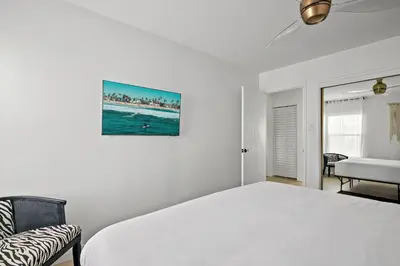 a white bedroom with a bed and a couch at Majestic Mermaid Retreat in San Diego