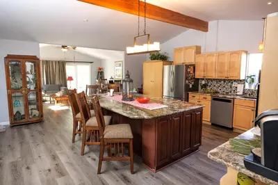 a kitchen with a large island in the middle at Family fun near the beach-sold in Oceanside