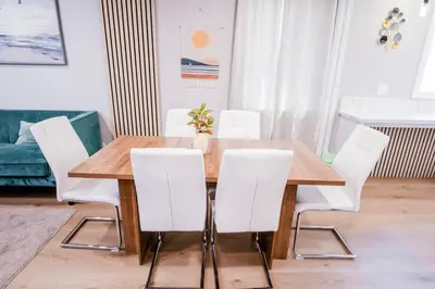 a dining room with a wooden table and white chairs at Exotic home Cumberland street by sdstay in San Diego