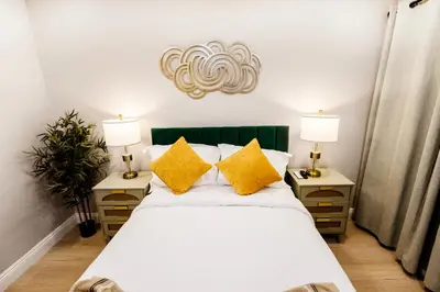 a bedroom with a large bed with yellow pillows at Exotic home Cumberland street by sdstay in San Diego