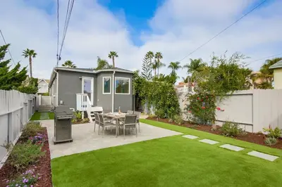 a small backyard with a table and a lawn at Newly Renovated Pacific Beach Home with Private Yard and AC in San Diego